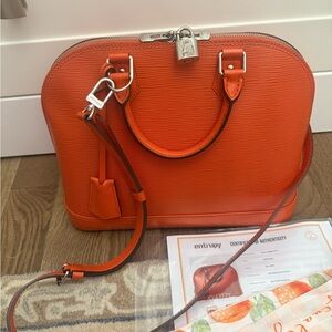 Authentic Louis Vuitton Orange Alma bag in like new condition. Full set!